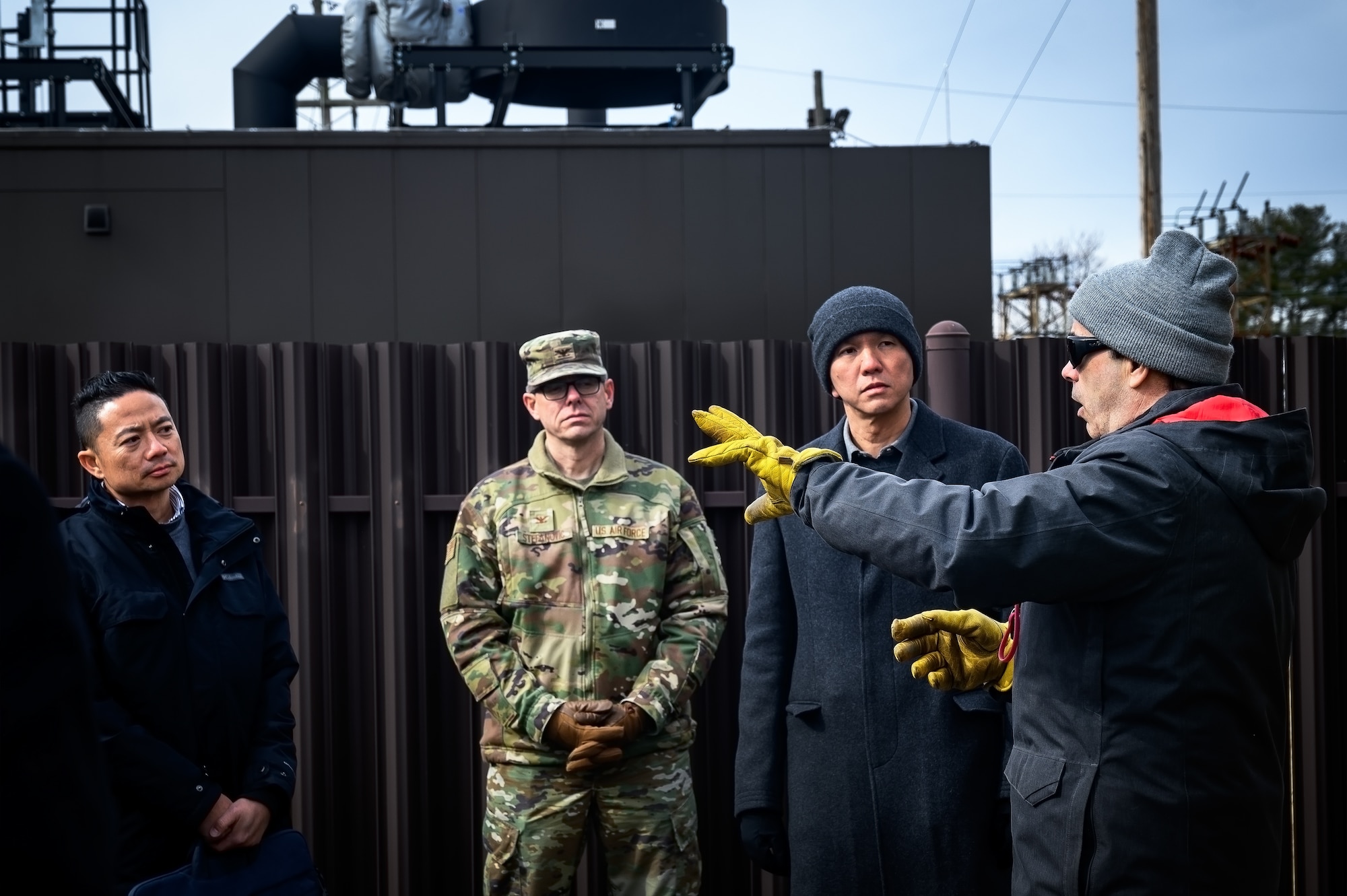 Alexander Vincent (right), 787th Civil Engineer Squadron energy and utilities supervisor, provides a brief about standby generators to Maj. Gen. Kelvin Fan (left), Republic of Singapore Air Force chief of staff, and RSAF staff members at Joint Base McGuire-Dix-Lakehurst, N.J., Feb. 20, 2025. The RSAF visit showcased JB MDL’s power sources such as standby generators, batteries, and a photovoltaic power station intended to improve grid resiliency and support day-to-day operations among its 89 mission partners. (U.S. Air Force photo by Senior Airman Matt Porter)