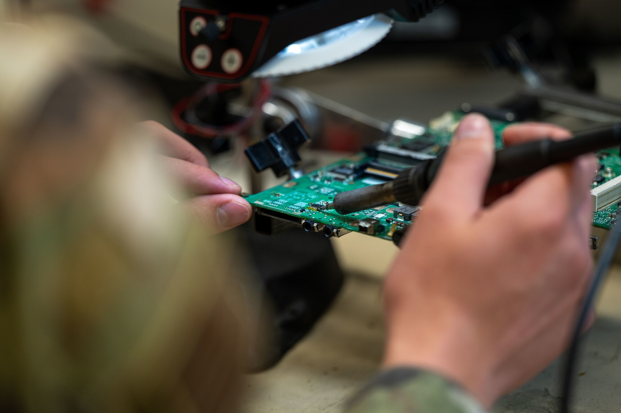 U.S. Air Force Staff Sgt. Shawn Powers, 9th Maintenance Air Force Repair Enhancement Program (AFREP) technician, solders a multilayer circuit card at Beale Air Force Base, California, Feb. 4, 2025.