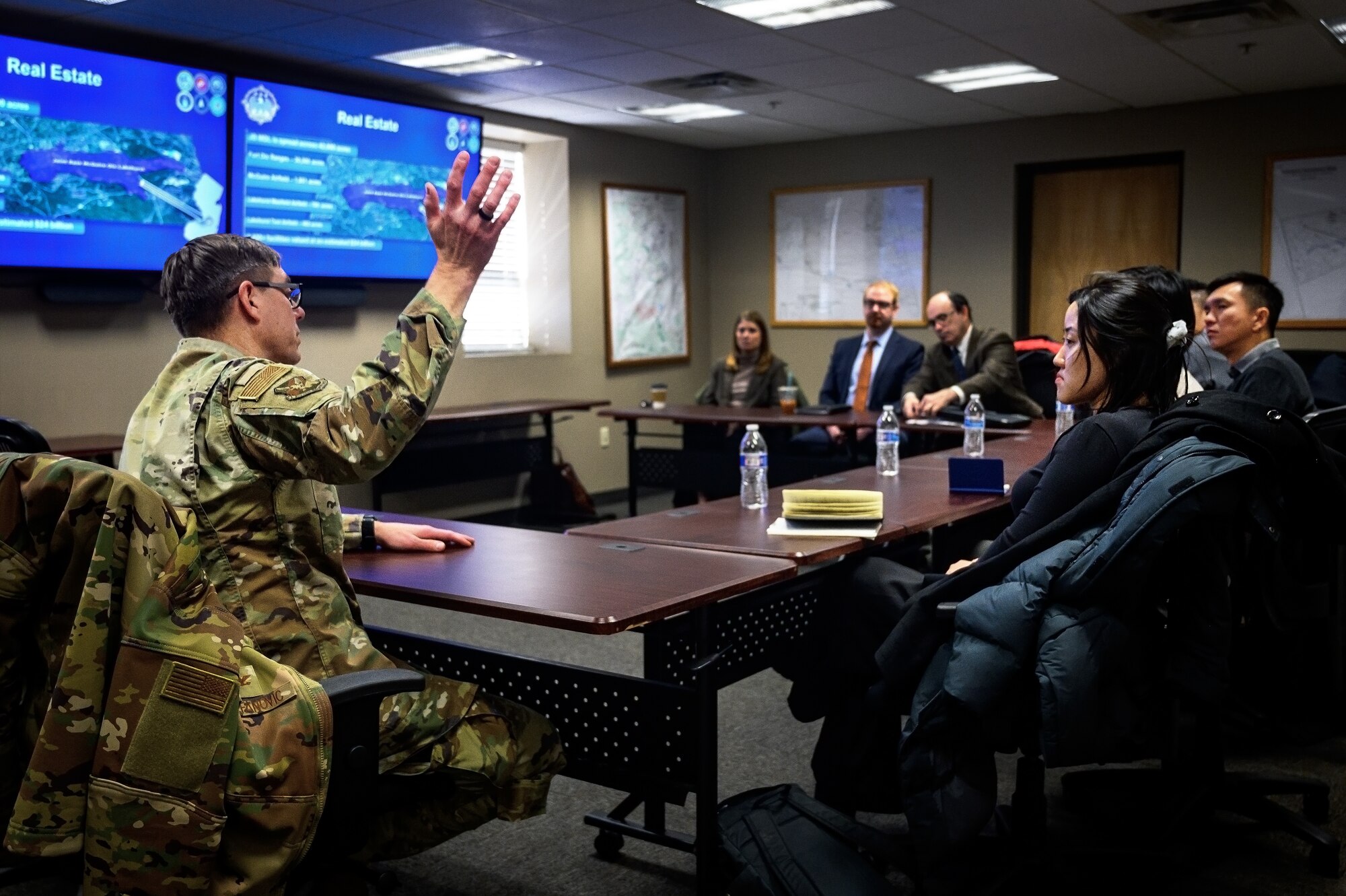U.S. Air Force Col. Michael Stefanovic (left), 87th Civil Engineer Group commander, briefs Maj. Gen. Kelvin Fan (right), Republic of Singapore Air Force chief of staff, and RSAF staff members at Joint Base McGuire-Dix-Lakehurst, N.J., Feb. 20, 2025. The RSAF visit showcased JB MDL’s power sources such as backup generators, batteries, and a photovoltaic power station intended to improve grid resiliency and support day-to-day operations among its 89 mission partners. (U.S. Air Force photo by Senior Airman Matt Porter)
