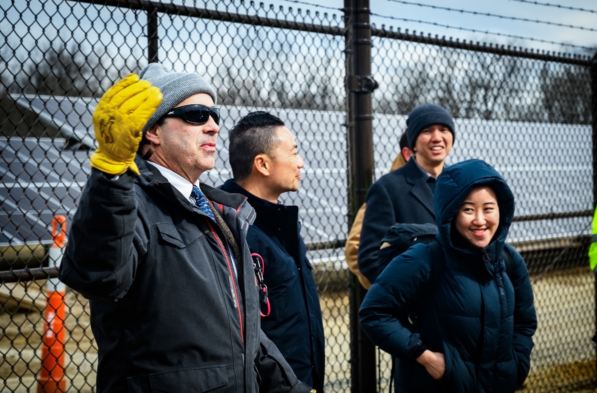 Alexander Vincent (left), 787th Civil Engineer Squadron energy and utilities supervisor, briefs Maj. Gen. Kelvin Fan (right), Republic of Singapore Air Force chief of staff, and RSAF staff members during a tour of the photovoltaic power station at Joint Base McGuire-Dix-Lakehurst, N.J., Feb. 20, 2025. The RSAF visit showcased JB MDL’s power sources such as standby generators, batteries, and a photovoltaic power station intended to improve grid resiliency and support day-to-day operations among its 89 mission partners. (U.S. Air Force photo by Senior Airman Matt Porter)