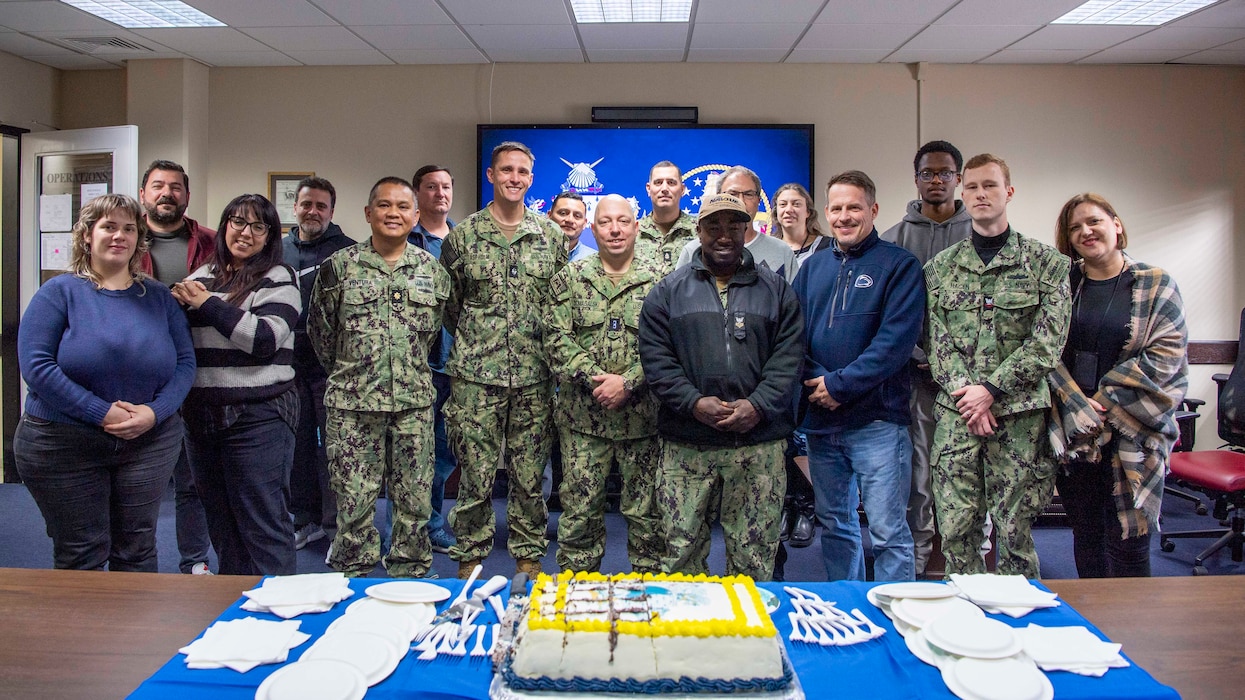 Sailors and personnel, assigned to Naval Support Activity Souda Bay, pose for a group photo during a celebration of the U.S. Navy Supply Corps’ 230th birthday onboard NSA Souda Bay, Crete, Greece, on Feb. 25, 2025.