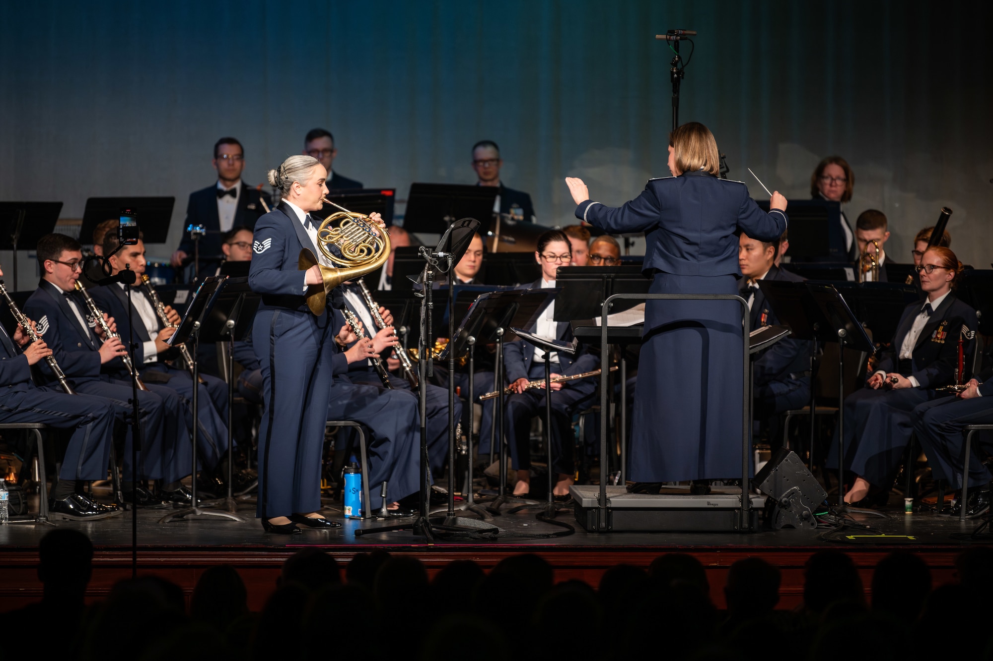 U.S. Air Force Staff Sgt. Abigail Martin with the USAF Band of Mid-America, performs a solo horn accompanied by a wind ensemble for the song "Harvest Light" at the Tullahoma High School in Tullahoma, Tenn., Feb. 15, 2025. Each year, the Band of Mid-America tours throughout a 10-state region performing for millions of people. (U.S. Air Force photo by Keith Thornburgh)