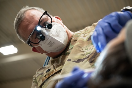 U.S. Air National Guard Lt. Col. Kevin Maskell, a dentist assigned to the Arizona Air National Guard 162nd Wing, examines a patient during Kodiac Arctic Care 24 in Kodiak, Alaska, May 9, 2024. U.S. Uniformed Services personnel joined Kodiak Arctic Care under the Innovative Readiness Training program, which partnered with the Kodiak Area Native Association to deliver free medical, dental optometry, and veterinary services on Alaska's remote Kodiak Island.
