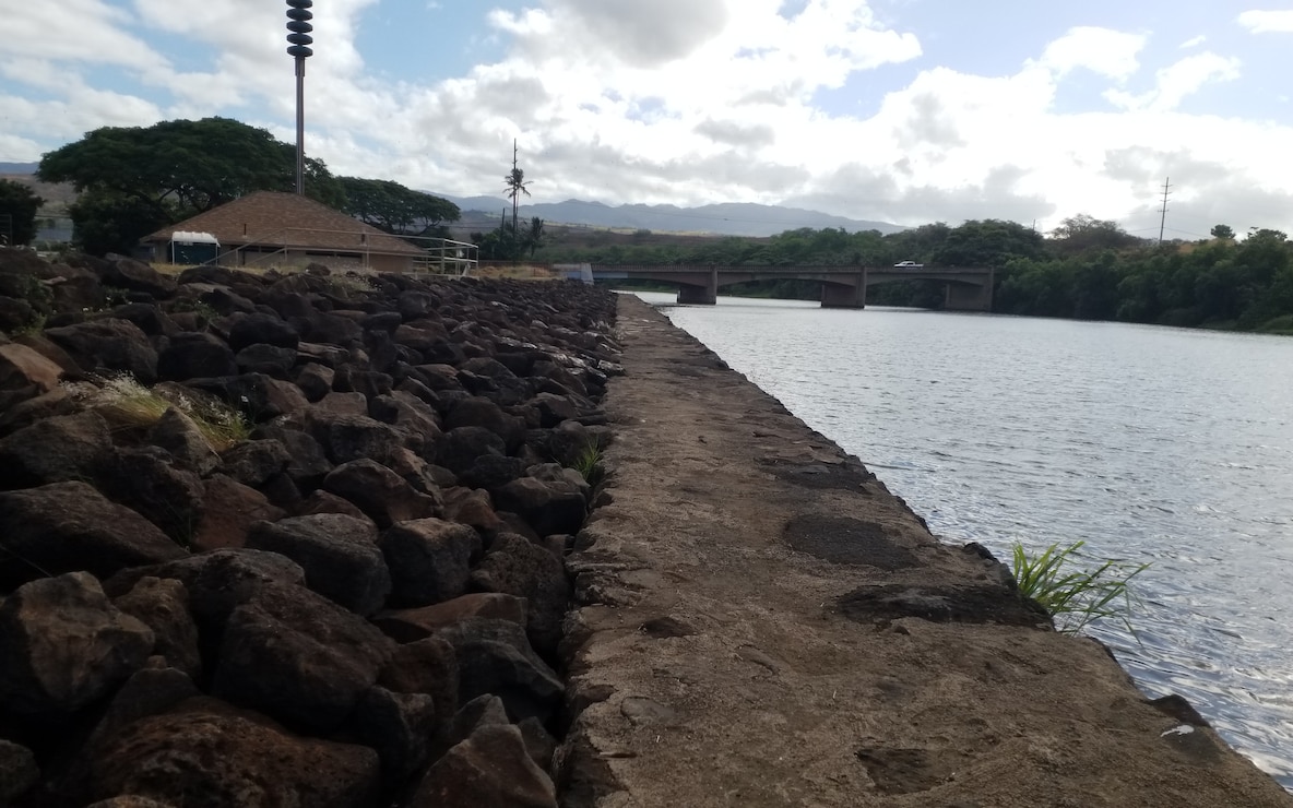 Waimea River Flood Control Project levee and concrete-rubble-masonry wall. Photo taken from right bank at Lucy Wright Park, facing upstream at Kaumuali'i Highway Bridge over Waimea River. (USACE, 2024)