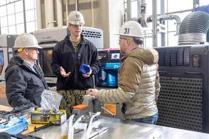 Seth Haskins, additive manufacturing manager, Shop 31, Inside Machinist, briefs Rear Adm. Peter Small Feb. 4, during a tour of Puget Sound Naval Shipyard & Intermediate Maintenance Facility facilities in Bremerton, Washington. (U.S. Navy photo by Wendy Hallmark)