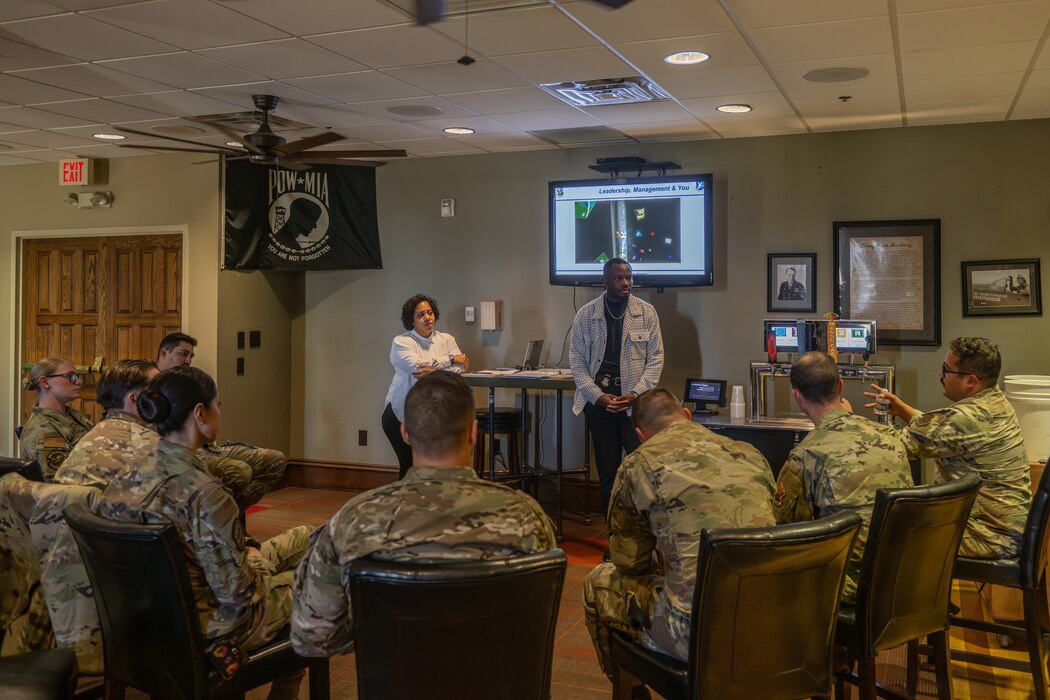 A group of military members sit during a brief