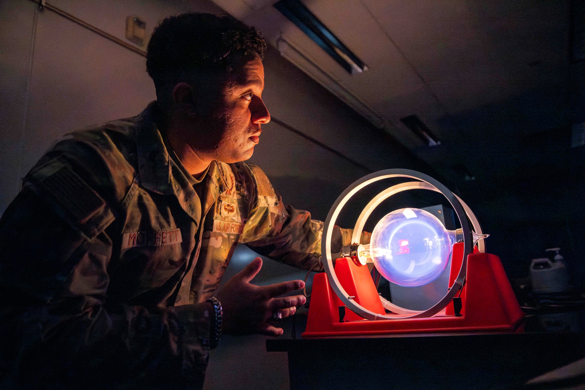 Maj. Kaz “Dexter” Moffett, U.S. Air Force Academy Physics instructor, teaches a lesson on the electromagnetic spectrum using an ion beam at the Academy, Colo., Feb. 12, 2025. In addition to his role as an instructor, Moffett actively mentors cadets who are considering careers in nuclear engineering, missile operations, or other technical fields. (U.S. Air Force photo by Trevor Cokley)