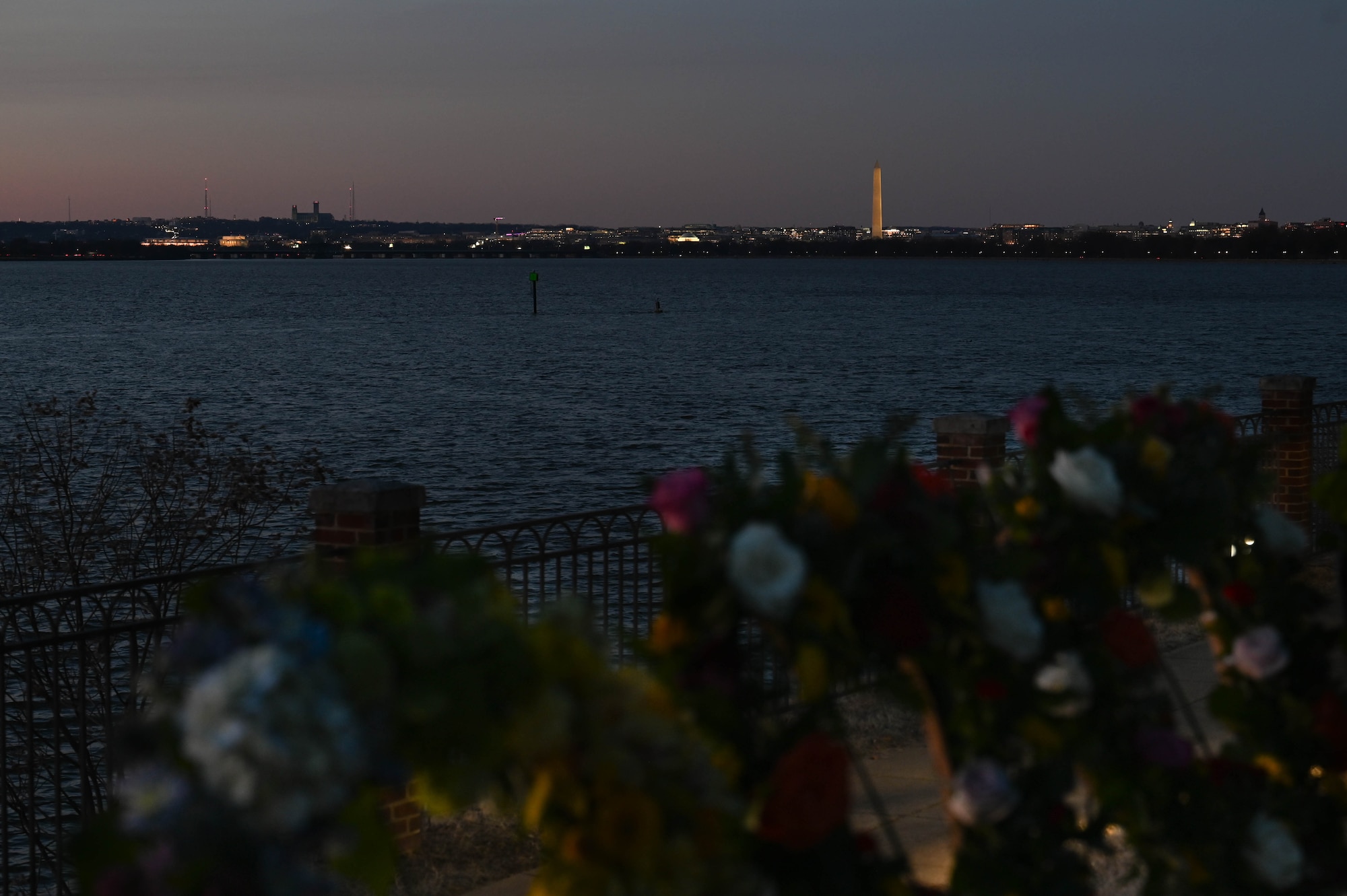 Wreaths are displayed during a candlelight vigil held on the waterfront at Joint Base Anacostia-Bolling, Washington, D.C., Feb. 18, 2025. The vigil honored the victims of an aircraft incident between a military helicopter and a passenger plane which happened adjacent to JBAB on Jan. 29. (U.S. Air Force photo by Airman 1st Class Geneva Nguyen)