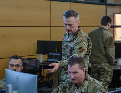 Maj. Joerge Baack, center, the 168th Cyberspace Operations Squadron director of operations, monitors his team during the International Cyber Defense Competition Feb. 22, 2025, at Iowa State University in Ames, Iowa. Cyber teams from the armed forces of Kosovo, Albania and Northern Macedonia participated with university teams from Iowa State, Kansas, DePaul, Northern Iowa, Drake and several Iowa high schools.