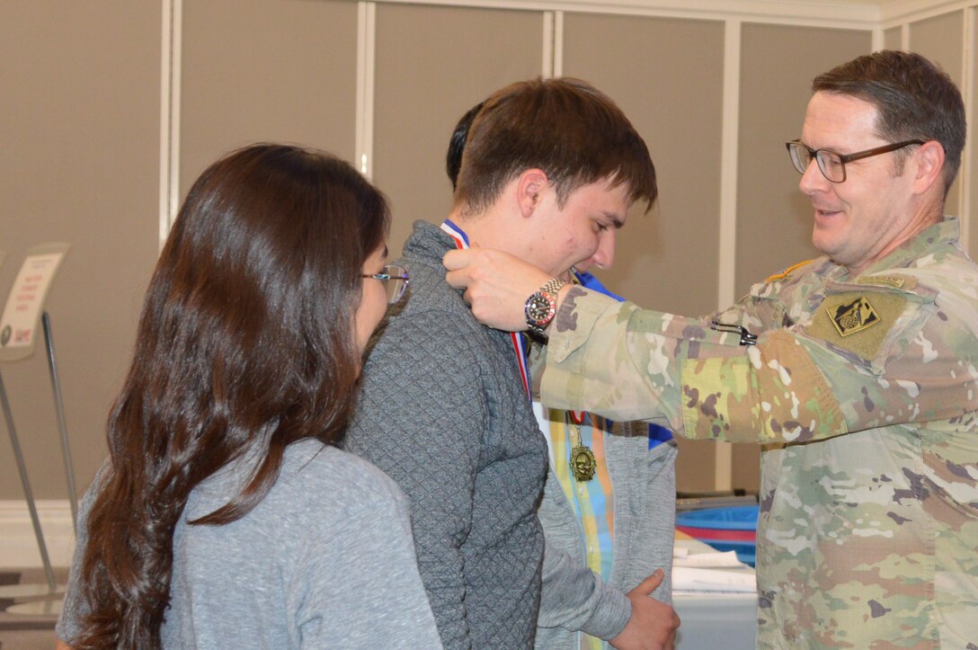 U.S. Army Corps of Engineers, Jacksonville District Commander, Col. Brandon Bowman presents awards medals to students participating in Engineering Career Day, an event hosted in partnership with The Society of American Military Engineers (SAME) Jacksonville Post at the Downtown Jacksonville Main Library.