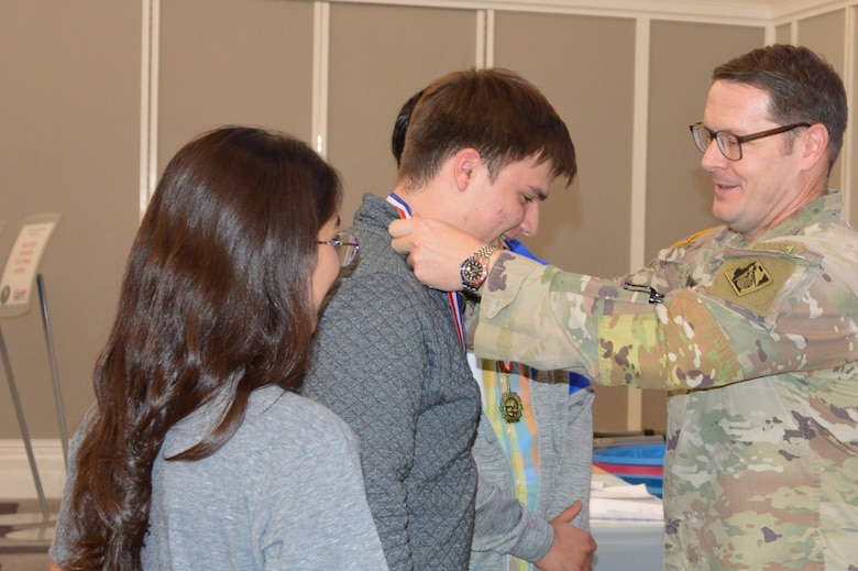 U.S. Army Corps of Engineers, Jacksonville District Commander, Col. Brandon Bowman presents awards medals to students participating in Engineering Career Day, an event hosted in partnership with The Society of American Military Engineers (SAME) Jacksonville Post at the Downtown Jacksonville Main Library.