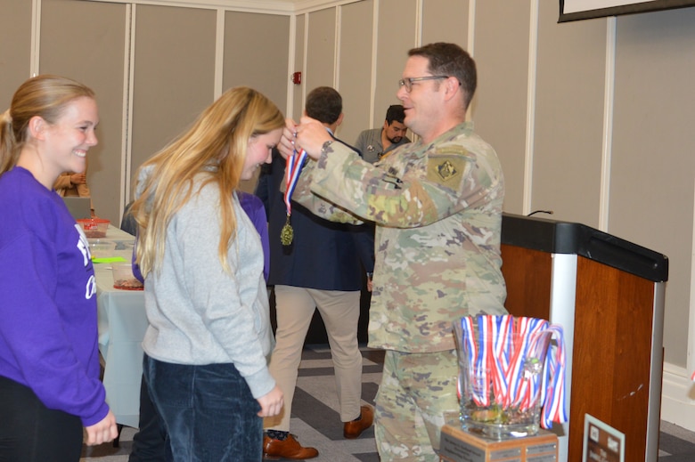 U.S. Army Corps of Engineers, Jacksonville District Commander, Col. Brandon Bowman presents awards medals to students participating in Engineering Career Day, an event hosted in partnership with The Society of American Military Engineers (SAME) Jacksonville Post at the Downtown Jacksonville Main Library.