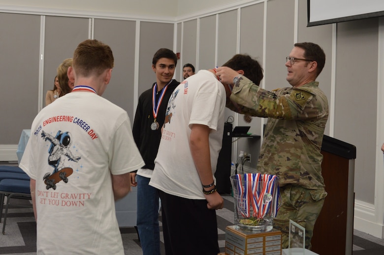U.S. Army Corps of Engineers, Jacksonville District Commander, Col. Brandon Bowman presents awards medals to students participating in Engineering Career Day, an event hosted in partnership with The Society of American Military Engineers (SAME) Jacksonville Post at the Downtown Jacksonville Main Library.