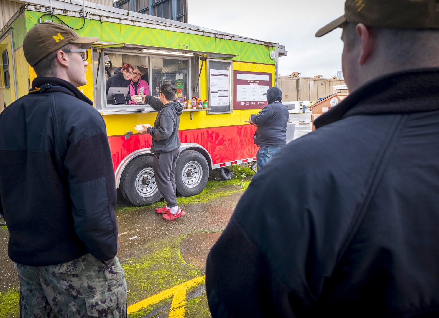 India Wadkins, left, and her mother, Stacey Wadkins, owner of Sweet Dahlia Baking, serve lunch to command employees, Feb. 19, 2025, from the former Juan's Food Trailer outside Building 460 at Puget Sound Naval Shipyard & Intermediate Maintenance Facility in Bremerton, Washington. Sweet Dahlia offers a different menu each day. (U.S. Navy photo by Wendy Hallmark)