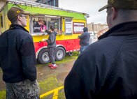 India Wadkins, left, and her mother, Stacey Wadkins, owner of Sweet Dahlia Baking, serve lunch to command employees, Feb. 19, 2025, from the former Juan's Food Trailer outside Building 460 at Puget Sound Naval Shipyard & Intermediate Maintenance Facility in Bremerton, Washington. Sweet Dahlia offers a different menu each day. (U.S. Navy photo by Wendy Hallmark)