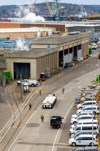 A team of Code 740, Riggers, maneuvers a self-propelled modular transport along Farragut Avenue Feb. 21, 2025, before delivering it to Dry Dock 5 at Puget Sound Naval Shipyard & Intermediate Maintenance Facility in Bremerton, Washington. (U.S. Navy photo by Wendy Hallmark)