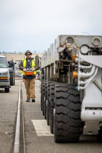 Thairon Sleeper, SPMT operator, Code 740, Riggers, maneuvers one of the code's six self-propelled modular transports along Farragut Avenue Feb. 21, 2025, en route to Dry Dock 5 at Puget Sound Naval Shipyard & Intermediate Maintenance Facility in Bremerton, Washington. (U.S. Navy photo by Wendy Hallmark)