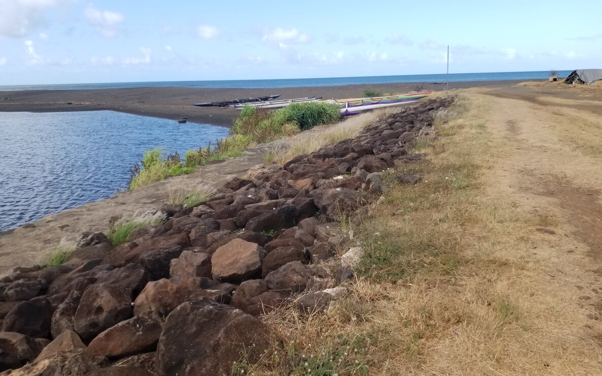 Terminus of Waimea River Flood Control Project levee. Photo taken from right bank, facing downstream at Waimea River stream mouth and Pacific Ocean. (USACE, 2024)