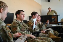 Tactical response force Airmen attend an exercise briefing.