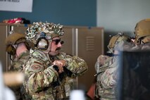 A tactical response force Airman gears up.