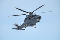 An MH-139A Grey Wolf helicopter is seen from below.