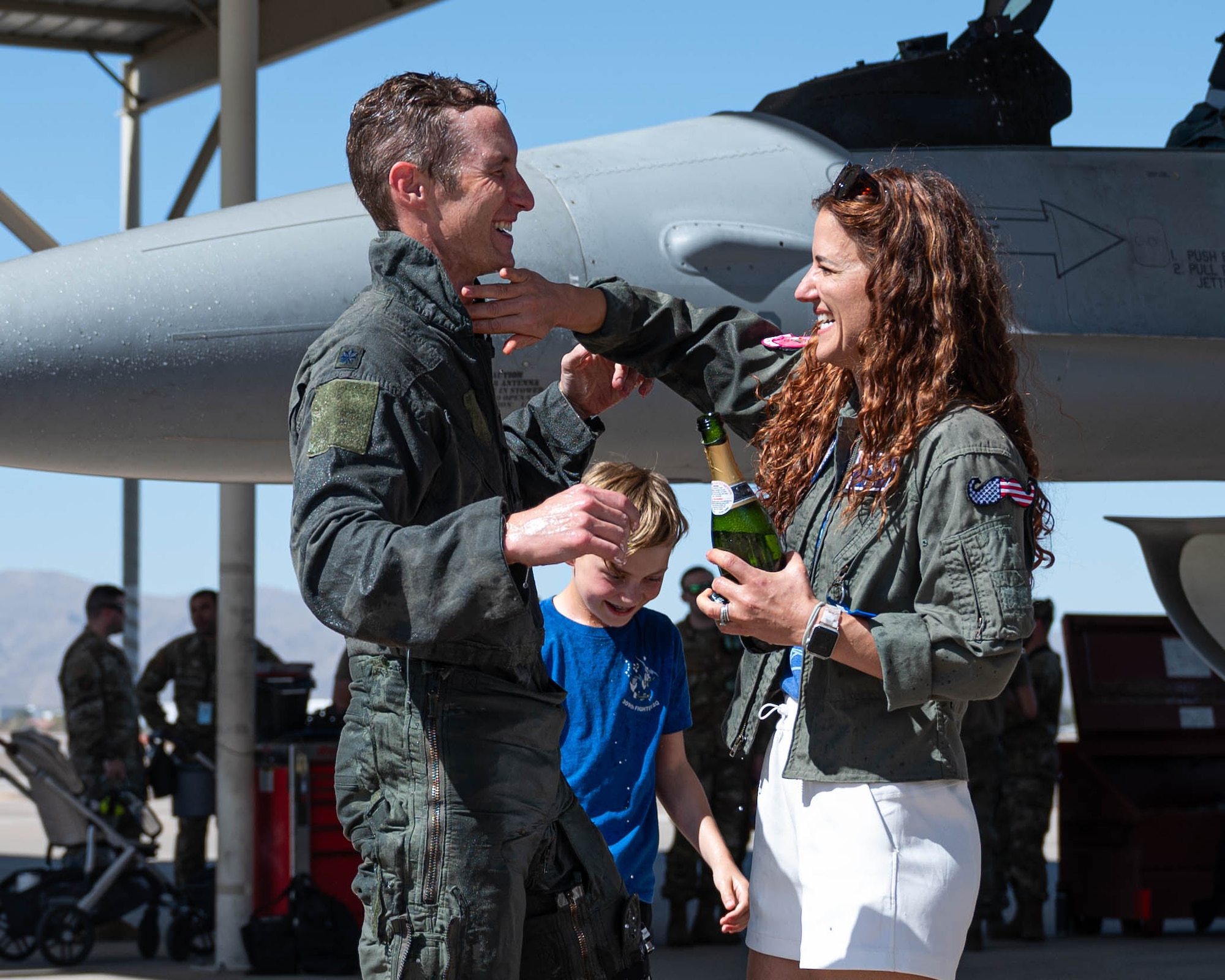 U.S. Air Force Lt. Col. Michael Ress, 309th Fighter Squadron commander, smiles as his wife wipes greets him after his final flight with the squadron, Feb. 26, 2025, at Luke Air Force Base, Arizona.