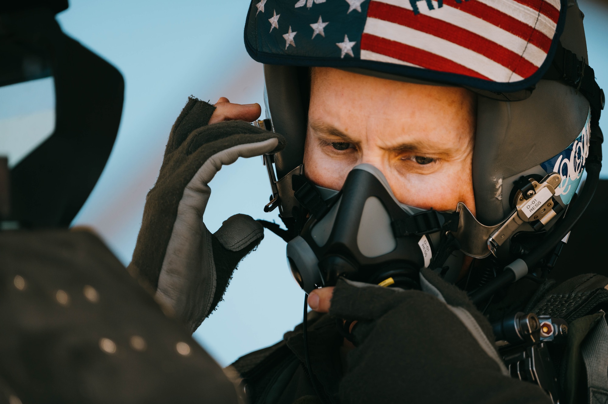 U.S. Air Force Lt. Col. Michael Ress, 309th Fighter Squadron commander, fastens his oxygen mask to his helmet in the cabin of a U.S. Air Force F-16 Fighting Falcon for the final F-16 flight of the 309th FS, Feb. 26, 2025, at Luke Air Force Base, Arizona.