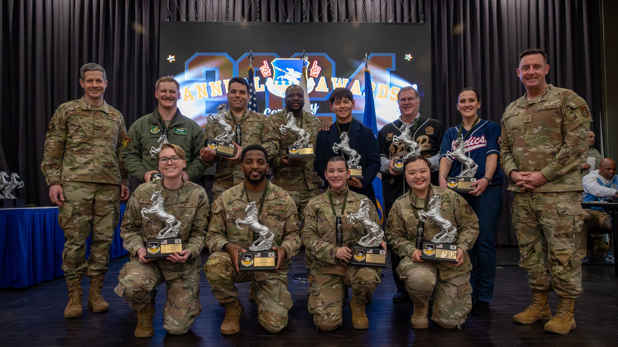 Winners of the 51st Fighter Wing Annual Awards Ceremony pose for a group photo with wing leadership at Osan Air Base, Republic of Korea, Feb. 21, 2025. The 51st FW regularly celebrates the outstanding achievements of its top performing Airmen, encouraging excellence through recognition and awards. (U.S. Air Force photo by Senior Airman Sabrina Fuller-Judd)