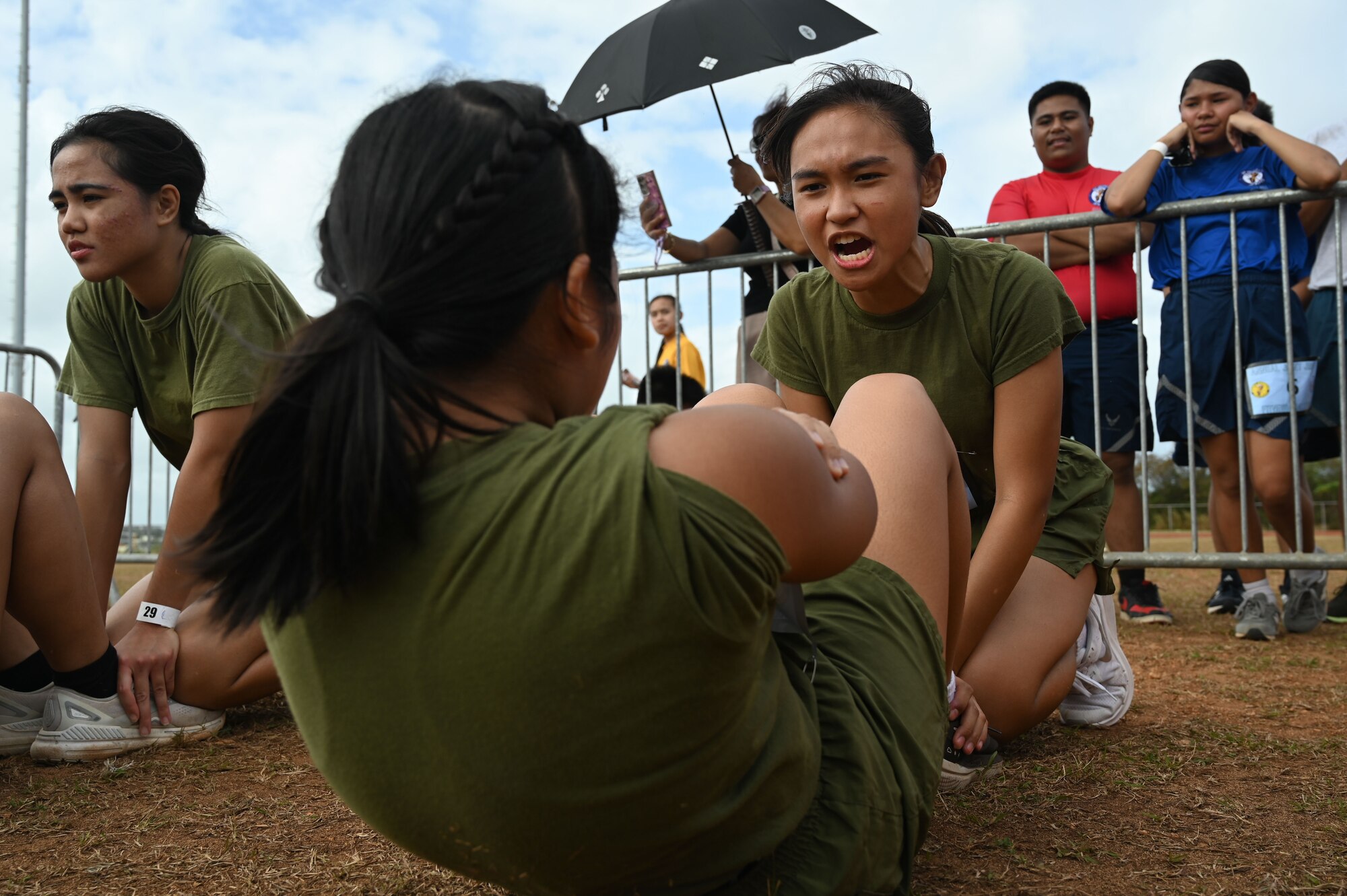 U.S. service members stationed in Guam and Guam Junior Reserve Officers’ Training Corps (JROTC) cadets pose for a picture after the annual JROTC Fitness Challenge at John F. Kennedy High School, Feb. 22, 2025. Five high schools participated in the event, and over 70 Air Force, Army, Navy, and Marine Corps service members volunteered to assist with boosting morale and fitness scores across the JROTC program.
