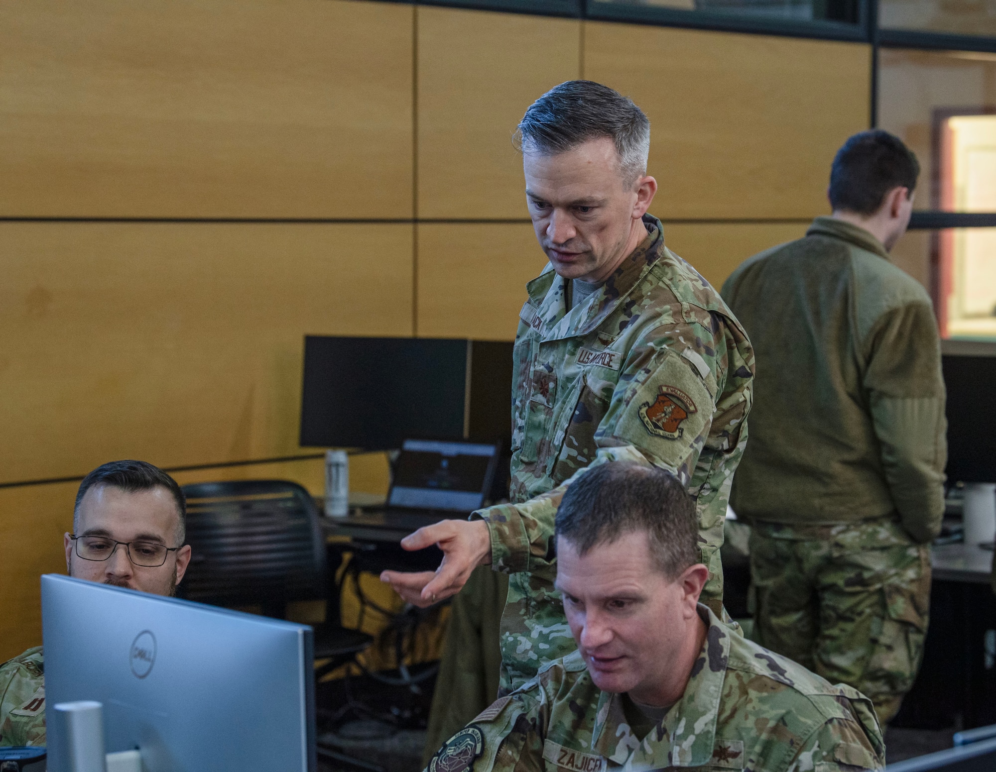 Maj. Joerge Baack, center, the 168th Cyberspace Operations Squadron director of operations, monitors his team during the International Cyber Defense Competition Feb. 22, 2025, at Iowa State University in Ames, Iowa. Cyber teams from the armed forces of Kosovo, Albania and Northern Macedonia participated with university teams from Iowa State, Kansas, DePaul, Northern Iowa, Drake and several Iowa high schools.