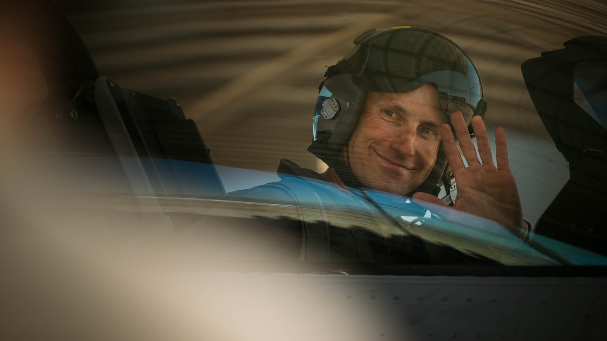 U.S. Air Force Lt. Col. Michael Ress, 309th Fighter Squadron commander, waves to friends and family after his final F-16 Fighting Falcon flight, Feb. 26, 2025, at Luke Air Force Base, Arizona.