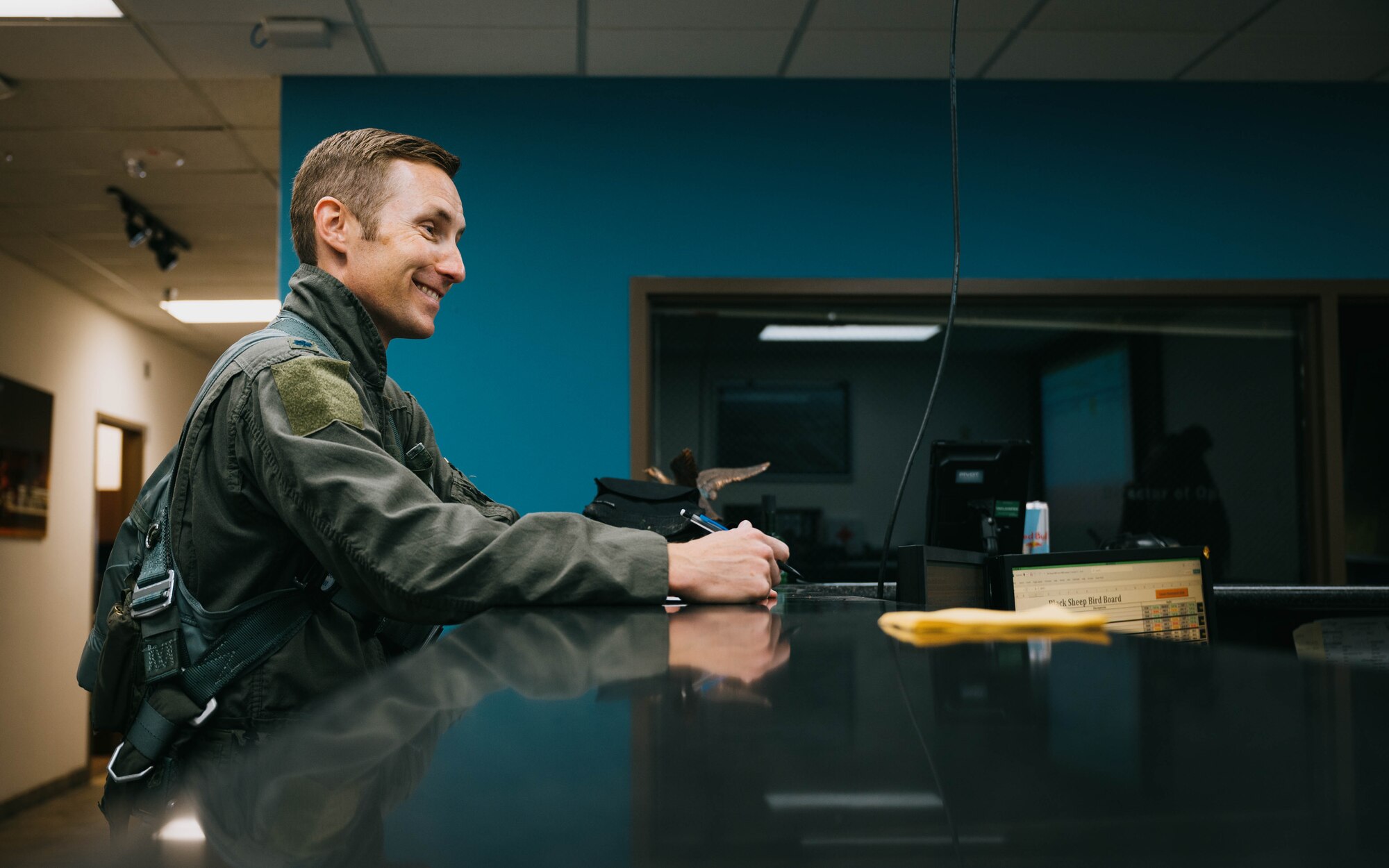 U.S. Air Force Lt. Col. Michael Ress, 309th Fighter Squadron commander, smiles at a 309th FS Airman during his pre-flight brief, Feb. 26, 2025, at Luke Air Force Base, Arizona.