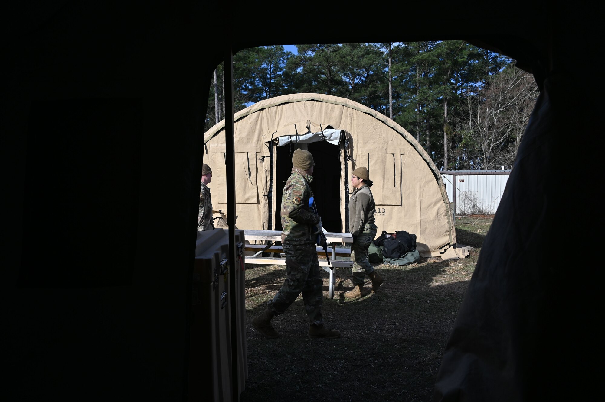 U.S. Airmen assigned to the 307th Civil Engineer Squadron carry a table to their designated area to stand up a unit control center February 21, 2025 at Barksdale Air Force Base, Louisiana.