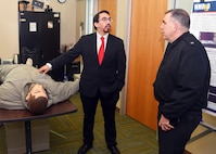 JOINT BASE SAN ANTONIO-FORT SAM HOUSTON - (Feb. 25, 2025) – Andres Martinez Murillo, a biomedical engineer assigned to Combat Casualty Care and Operational Medicine, Naval Medical Research Unit (NAMRU) San Antonio, talks about tactical combat casualty care (TCCC) treatments on a trauma manikin in extreme cold with Rear Adm. Matthew Case, director, U.S. Navy Medical Service Corps at the Battlefield Health and Trauma Research Institute. Case, who additional serves as the director of the Navy Medical Service Corps, visited NAMRU San Antonio to better understand the unit’s mission, capabilities, and impact to Navy Medicine. NAMRU San Antonio is one of eight research laboratories within Navy Medicine Research and Development. Its mission is to conduct gap driven combat casualty care, craniofacial, and directed energy research to improve survival, operational readiness, and safety of Department of Defense personnel engaged in routine and expeditionary operations. (U.S. Navy photo by Burrell Parmer, NAMRU San Antonio Public Affairs/Released)