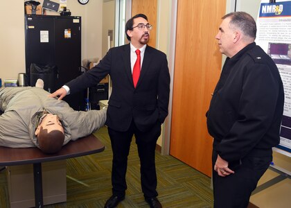 JOINT BASE SAN ANTONIO-FORT SAM HOUSTON - (Feb. 25, 2025) – Andres Martinez Murillo, a biomedical engineer assigned to Combat Casualty Care and Operational Medicine, Naval Medical Research Unit (NAMRU) San Antonio, talks about tactical combat casualty care (TCCC) treatments on a trauma manikin in extreme cold with Rear Adm. Matthew Case, director, U.S. Navy Medical Service Corps at the Battlefield Health and Trauma Research Institute. Case, who additional serves as the director of the Navy Medical Service Corps, visited NAMRU San Antonio to better understand the unit’s mission, capabilities, and impact to Navy Medicine. NAMRU San Antonio is one of eight research laboratories within Navy Medicine Research and Development. Its mission is to conduct gap driven combat casualty care, craniofacial, and directed energy research to improve survival, operational readiness, and safety of Department of Defense personnel engaged in routine and expeditionary operations. (U.S. Navy photo by Burrell Parmer, NAMRU San Antonio Public Affairs/Released)