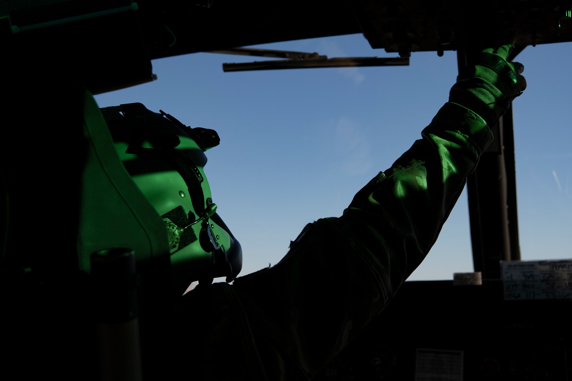 An airman conducts a pre-flight check.