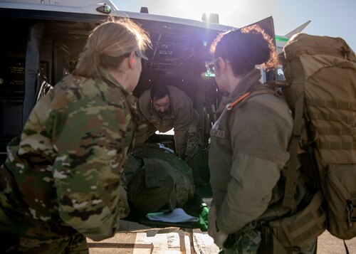 Airmen transport a simulated patient.