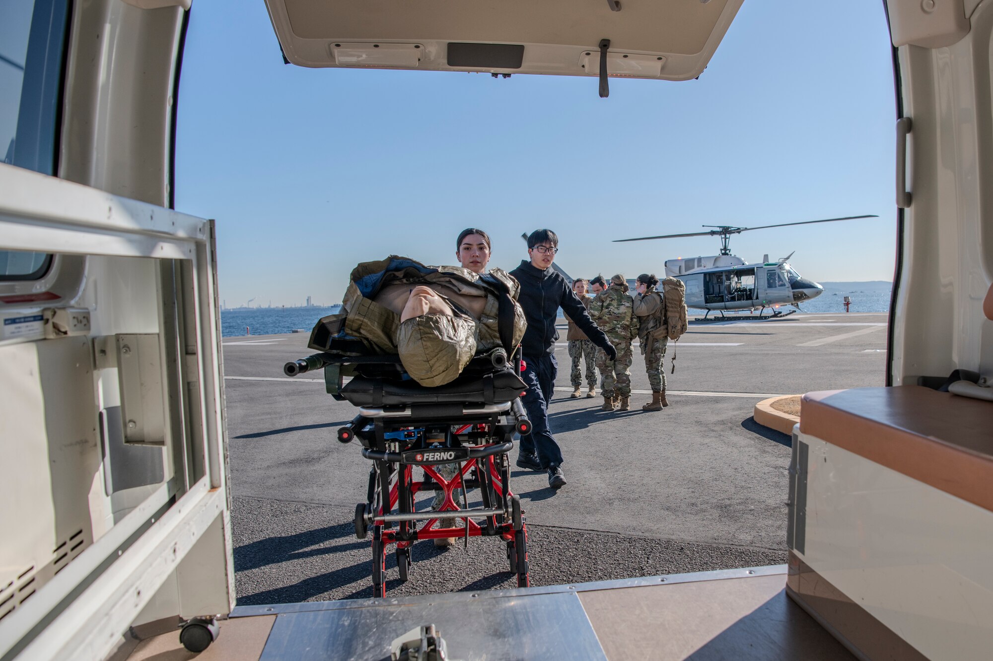 Members push a simulated patient on a litter