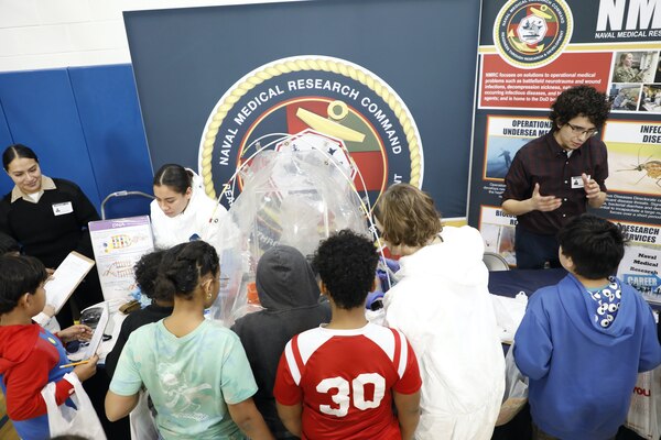 SILVER SPRING, Md. (Feb. 26, 2025) Staff with Naval Medical Research Command (NMRC), interact with students from Sargent Shriver Elementary School at the school’s annual Career Day. Representatives from NMRC spent the day with 3rd, 4th and 5th graders answering questions, discussing careers within Navy Medicine and demonstrating laboratory equipment. NMRC is engaged in a broad spectrum of activities, from basic science in the laboratory to field studies in austere and remote areas of the world to investigations in operational environments. In support of the Navy, Marine Corps, and joint U.S. warfighters, researchers study infectious diseases, biological warfare detection and defense, combat casualty care, environmental health concerns, aerospace and undersea medicine, medical modeling, simulation, operational mission support, epidemiology and behavioral sciences. (U.S. Navy photo by Elliott Page /Released)