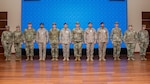 A mobile training team of U.S. Airmen assigned to Air Forces Central poses for a photo with Royal Saudi Air Force members during the graduation ceremony of the inaugural Chief Leadership Course in the Kingdom of Saudi Arabia Jan. 23, 2025. The 17-day course was modeled after the USAF’s CLC, incorporating lessons from the First Sergeants’ and Noncommissioned Officer academies.