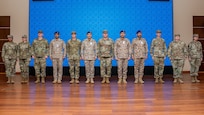 A mobile training team of U.S. Airmen assigned to Air Forces Central poses for a photo with Royal Saudi Air Force members during the graduation ceremony of the inaugural Chief Leadership Course in the Kingdom of Saudi Arabia Jan. 23, 2025. The 17-day course was modeled after the USAF’s CLC, incorporating lessons from the First Sergeants’ and Noncommissioned Officer academies.
