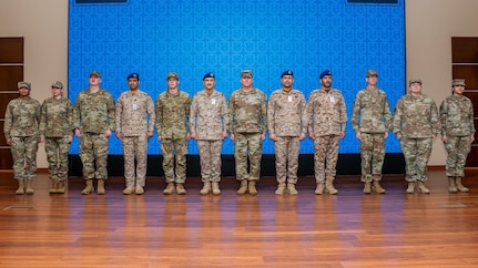 A mobile training team of U.S. Airmen assigned to Air Forces Central poses for a photo with Royal Saudi Air Force members during the graduation ceremony of the inaugural Chief Leadership Course in the Kingdom of Saudi Arabia Jan. 23, 2025. The 17-day course was modeled after the USAF’s CLC, incorporating lessons from the First Sergeants’ and Noncommissioned Officer academies.