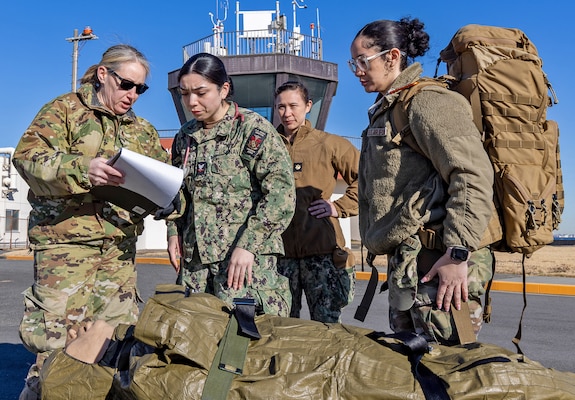 YOKOSUKA, Japan (Feb. 20, 2025) U.S. Air Force Airmen assigned to the 374th Medical Group transfer a simulated patient to U.S. Naval Hospital (USNH) Yokosuka during a mass casualty drill. USNH Yokosuka and 374th Medical Group from Yokota conducted a surgical team assist and medical evacuation (MEDEVAC) operation during the joint mass casualty drill. The drill tested the efficiency of transporting a surgeon from Yokosuka to Yokota via 459th Airlift Squadron while simultaneously evacuating a Yokota-based trauma patient to a higher level of care in Yokosuka. (U.S. Navy photo by Daniel Taylor/USNMRTC Yokosuka Public Affairs)