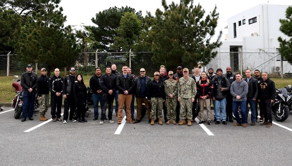 250220-N-DO281-1044 OKINAWA, Japan (Feb. 20, 2025) – Navy Medicine Readiness and Training Command Okinawa leaders, service members and members of the American Legion Riders pose for a photo before a motorcycle safety ride through Okinawa, Japan, Feb. 20, 2025. (U.S. Navy photo by Mass Communication Specialist 1st Class Trey Fowler)
