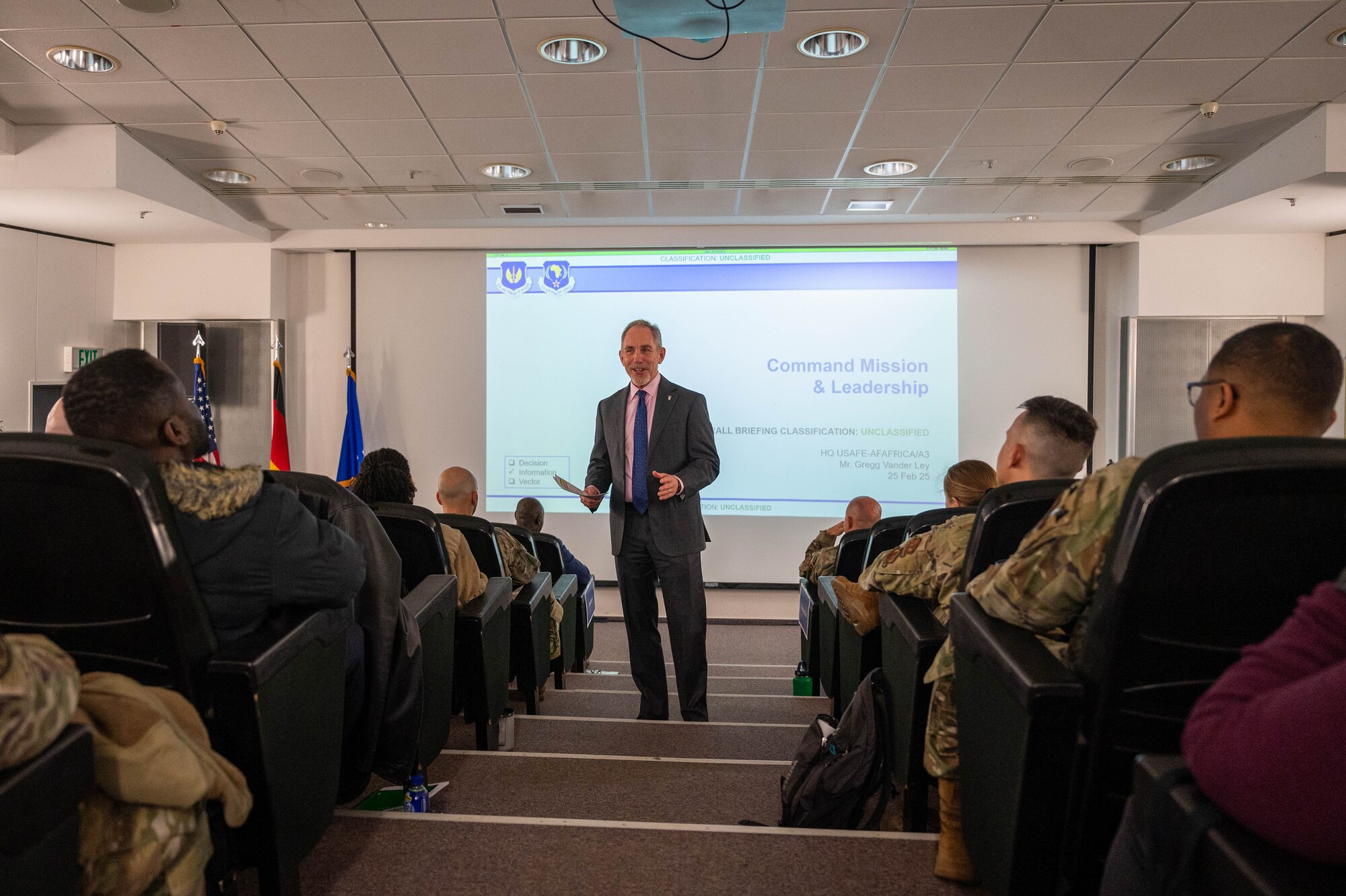 Gregg Vander Ley, U.S. Air Forces in Europe - Air Forces Africa A/3 deputy director, briefs an audience about theater-level operational changes during the USAFE-AFAFRICA 2025 Budget Symposium on Ramstein Air Base, Germany, Feb. 25, 2025. The event focused on providing individuals with the strategic information necessary to align to the USAFE-AFAFRICA mission vision.