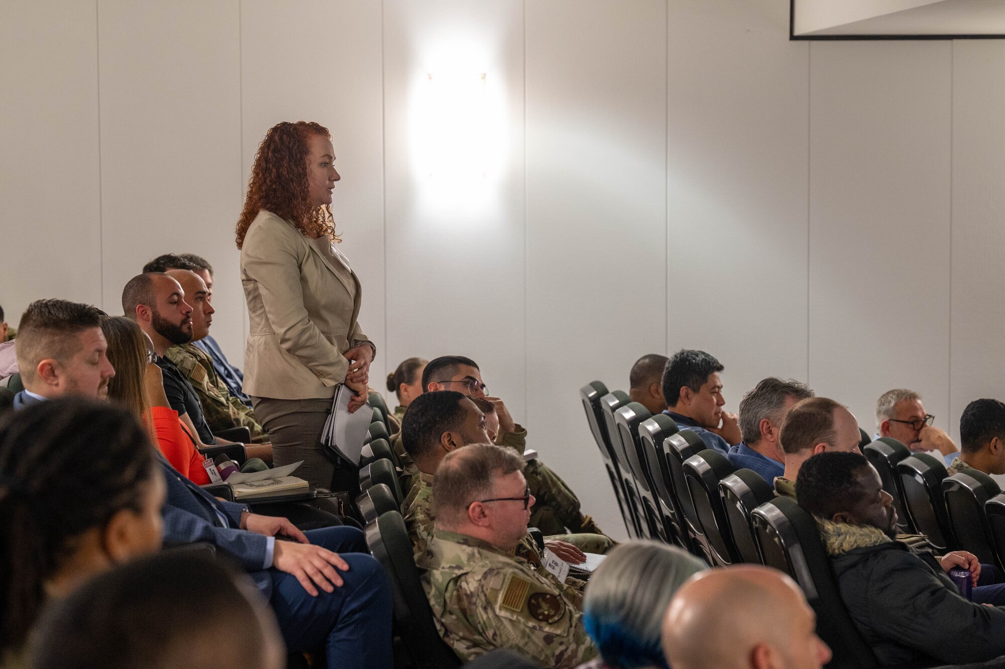 Becky LaRaia, U.S. Air Forces in Europe - Air Forces Africa financial operations division chief, asks a question to leadership during the USAFE-AFAFRICA 2025 Budget Symposium at Ramstein Air Base, Germany, Feb. 25, 2025. The event sought to bring together financial managers and resource advisors within USAFE-AFAFRICA to ensure members had the strategic concepts and tools to maximize their capabilities in executing the financial management mission.