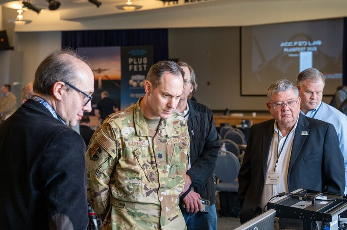Dr. Ilya Lipkin, left, Senior Engineer, Air Combat Command Federal Laboratory and U.S. Air Force Lt. Col. Nathan Maertens, Chief of Staff 9th Reconnaissance Wing, observe open architecture equipment at PlugFest on Feb. 10, 2025 at Beale Air Force Base, California.