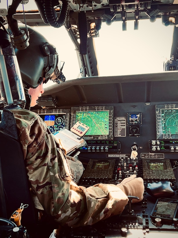 Chief Warrant Officer 5 Anthony Villier, a pilot with Bravo Co 2/147th aviation, performs routine in-flight checks in eastern Kentucky while searching for stranded flood survivors on February 17, 2025.