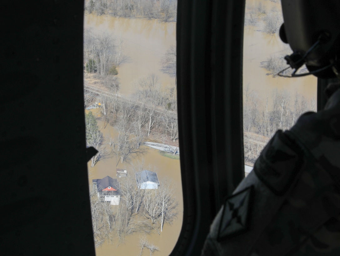 Sgt. Charles Hall, crew chief from Charlie Co 2-238th MEDEVAC, scans waterways in eastern Kentucky for stranded flood survivors on February 17, 2025.