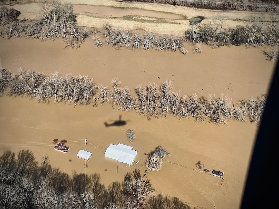 A Kentucky Army National Guard 63rd Theater Aviation Brigade UH-60 Black Hawk flies over waterways in eastern Kentucky in search of stranded flood survivors on February 17, 2025.